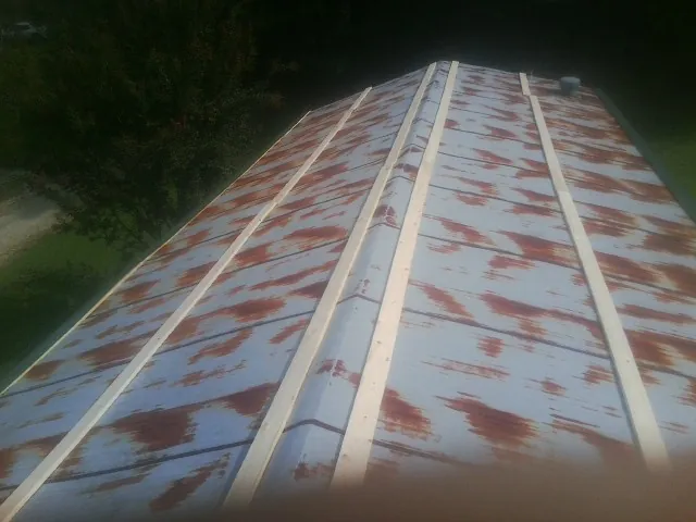 Rusted metal roof panels with new wood purlins before replacement — Storm Damage Roof Repair in Browns Mills by Roofing Brothers