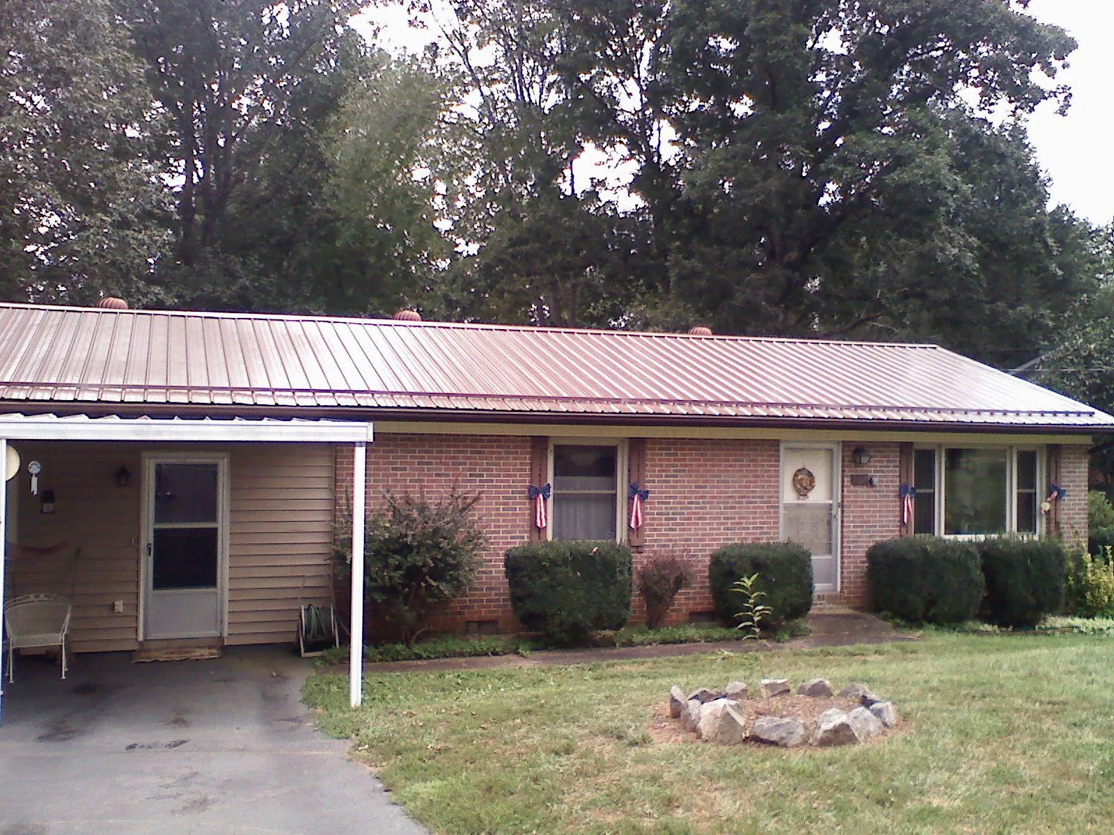 Bronze metal roof and carport on a brick ranch home — Roof Repair work by our crew in Browns Mills